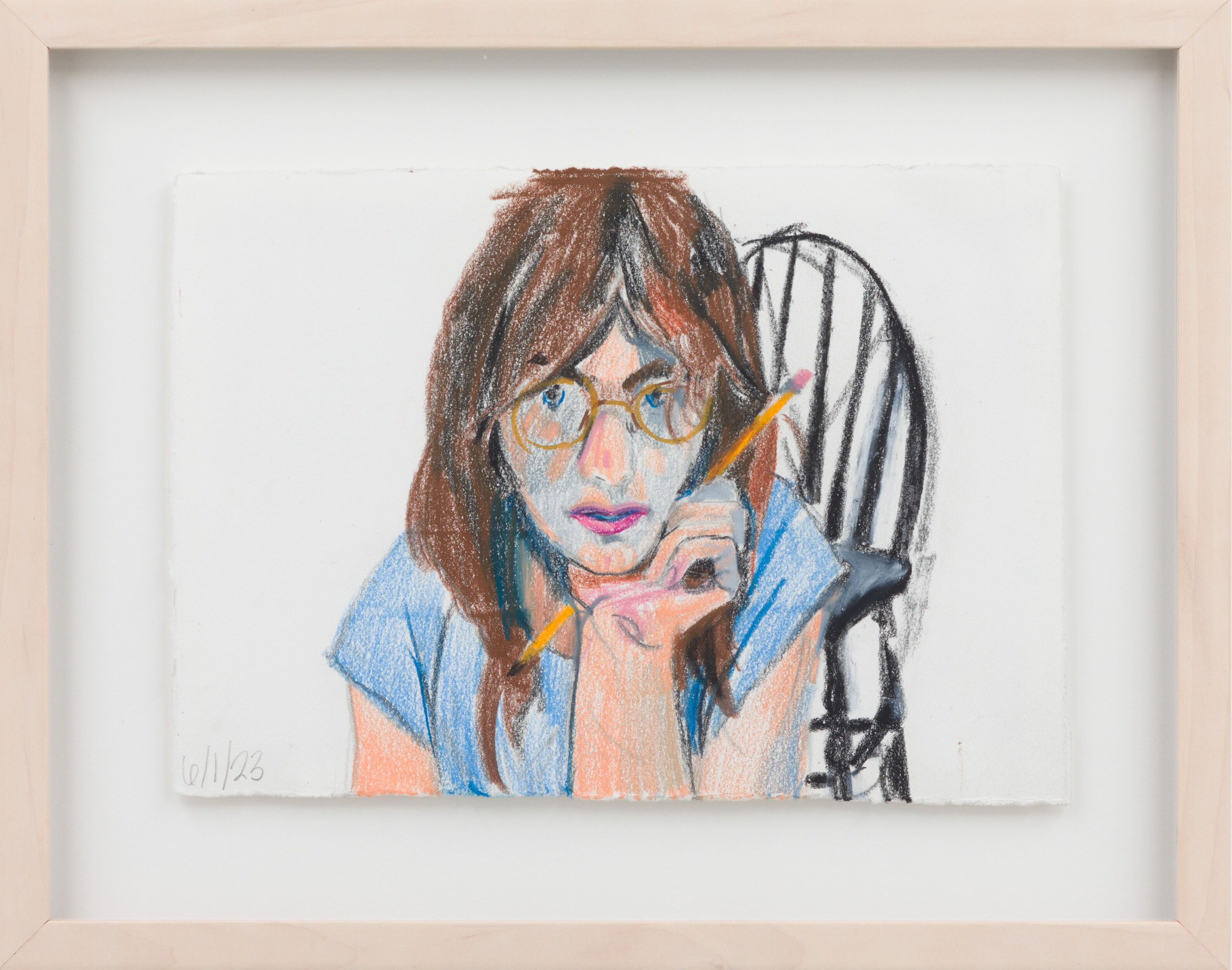 A crayon and graphite self-portrait by the artist Michelle Uckotter, seen here holding a pencil